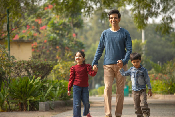 istock Father with children enjoying in park 1857284166