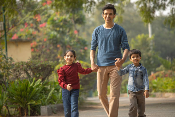 istock Father with children enjoying in park 1857284680