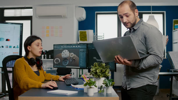 istock Project supervisor holding laptop and talking with woman engineer 1857287824