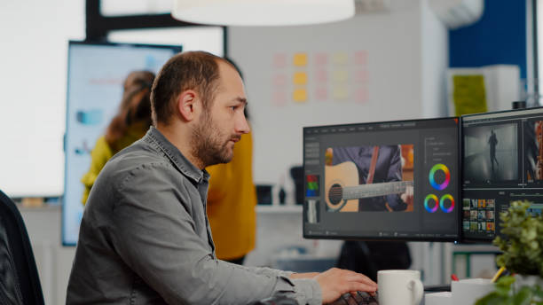 istock Man video editor looking at camera, working with footage 1857297464