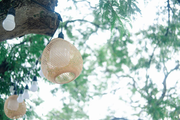 istock Bamboo woven lamp hanging on tree decoration in the garden 1857314217