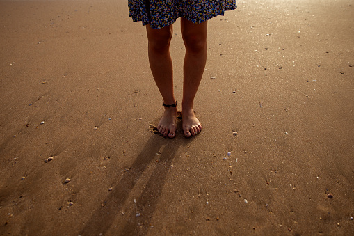 woman's feet in the wet sand