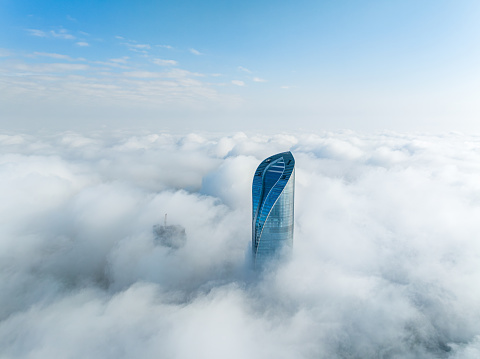 China, Jiangsu, Suzhou Industrial Park, taking aerial photos of Suzhou International Financial Center on the advection fog