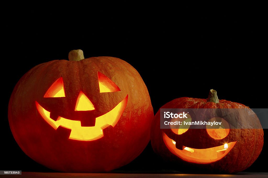 A picture of two Halloween pumpkins Two glowing Halloween pumpkins on black background Carving - Craft Product Stock Photo