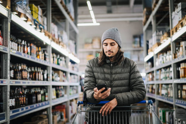 man in a liquor store. - eastern european caucasian one person alcoholism imagens e fotografias de stock