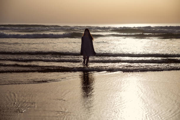 istock young woman taking a walk at the seashore 1857337855