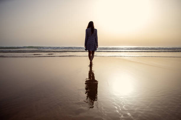 young woman taking a walk at the seashore