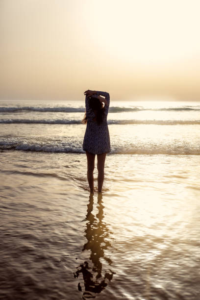 istock young woman taking a walk at the seashore 1857338978