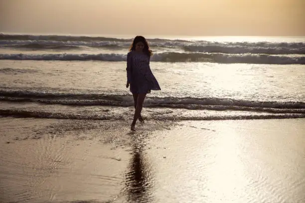 young woman taking a walk at the seashore