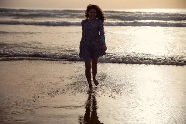 young woman taking a walk at the seashore