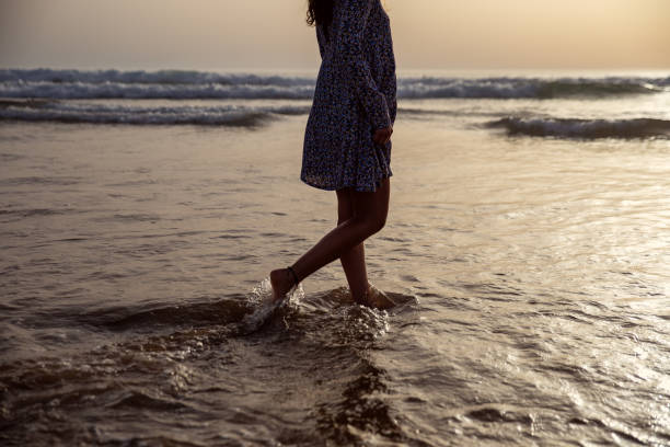 istock young woman taking a walk at the seashore 1857340701