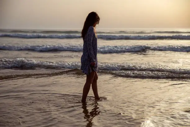 young woman taking a walk at the seashore
