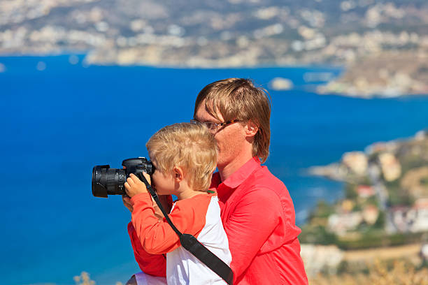 istock father and son making photo on beach vacation 185734138
