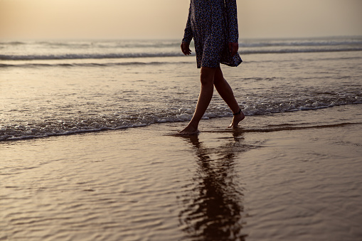 young woman taking a walk at the seashore