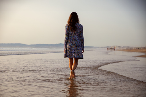 young woman taking a walk at the seashore