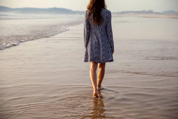 young woman taking a walk at the seashore