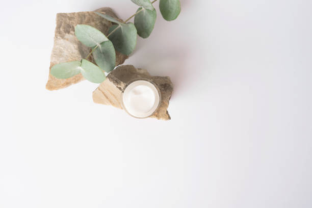 istock Skin care products, face moisturizer with open lid with eucalyptus on stone 1857349833