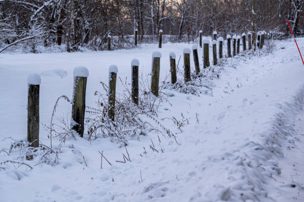 istock Bollards covered in snow standing beside a road 1857366116
