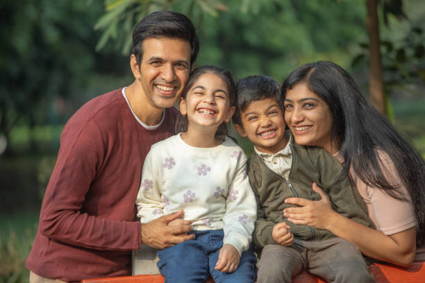 istock Happy family enjoying weekend in park 1857384263