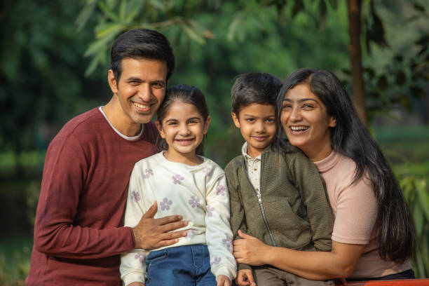 istock Happy family enjoying weekend in park 1857384789