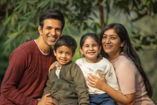 istock Happy family enjoying weekend in park 1857385852