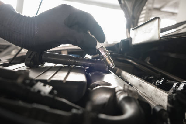 istock Mechanic man hand repair ignition on car engine 1857387134