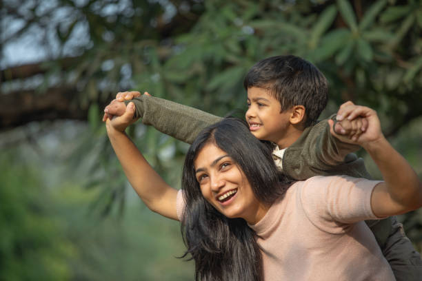 istock Mother piggybacking son in garden 1857396382