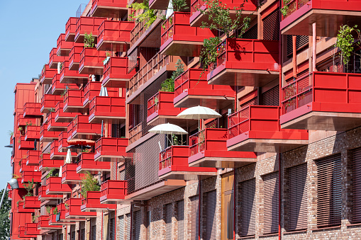 New red apartment building with balconies seen in Berlin, Germany