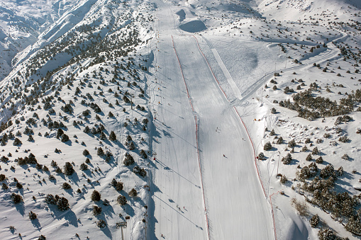 Ski areas in the Dolomites - European Alps. Ski lift taking people to the top.