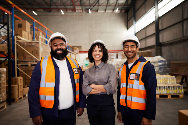 istock Smiling group of engineers standing together in a shipping warehouse 1857445785