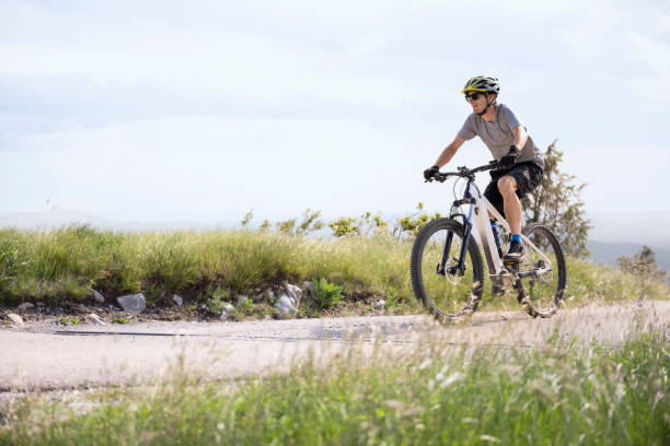 istock Man riding electric bicycle on road 1857446865