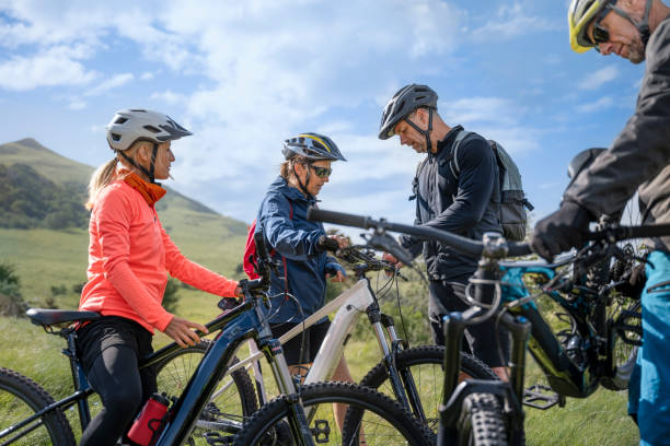 istock Male and female mountain biker talking while getting ready 1857449403