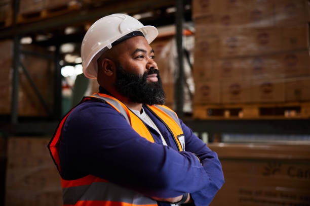 istock Male engineer standing by shelves in a large shipping warehouse 1857452705