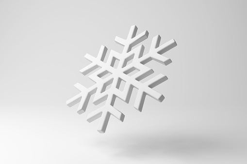 White snowflake floating in mid air on white background in monochrome and minimalism. Illustration of the concept of winter