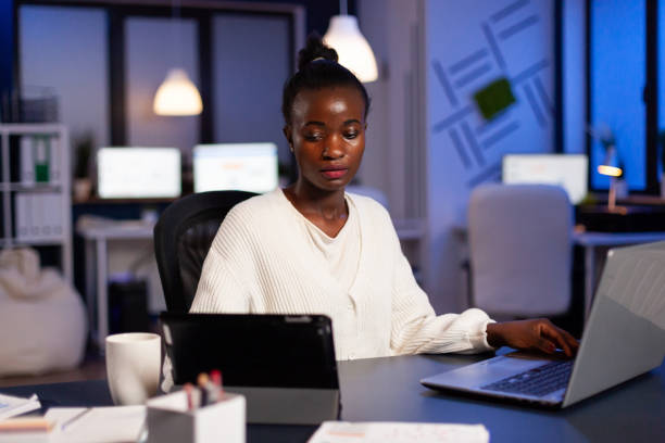 istock Overworked african businesswoman checking charts on tablet pc 1857460114