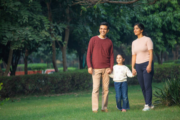 istock Happy parents and daughter looking away in park 1857460633
