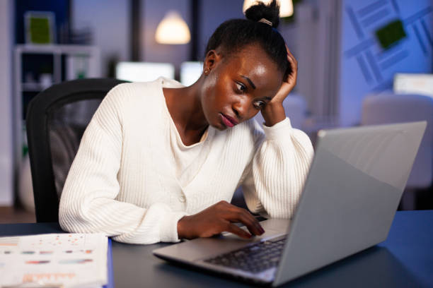 istock Exhausted african freelancer resting head on hand in front of laptop 1857462213