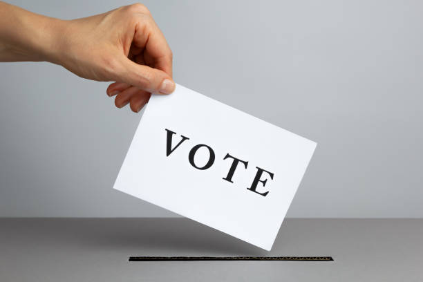istock A hand throws a ballot into a box on Election Day. Voting concept. 1857465843