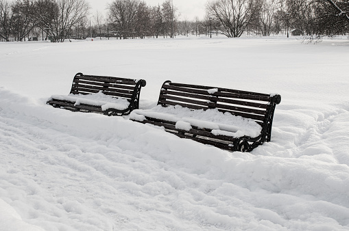 Park benches covered snow in winter park