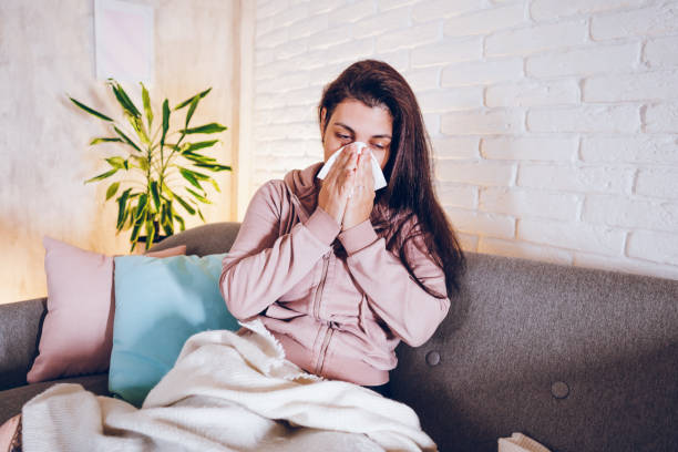 istock Sick woman sitting at home 1857473245