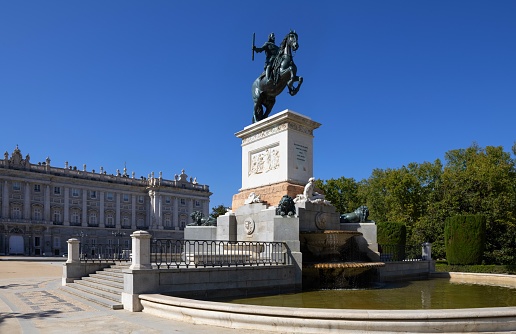 Madrid, Spain, October 6, 2023: View of tha Plaza de Oriente with the Monument to the king Felipe IV in front of the Royal Palace in the downtown of Madrid on a sunny autumn day.