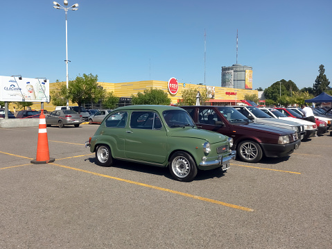 Buenos Aires, Argentina - Dec 10, 2023: old green 1970s Fiat 600 sedan two door rear engined unibody at a classic car show in a parking lot. Sunny day. Copy space