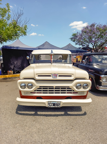 Buenos Aires, Argentina - Dec 10, 2023; Old 1960 Ford F 100 Loba pickup truck at a classic car show in a parking lot. Front view. Grille. Sunny day. Copy space