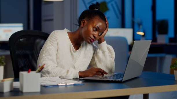 istock Exhausted african freelancer resting head on hand in front of laptop working 1857518811