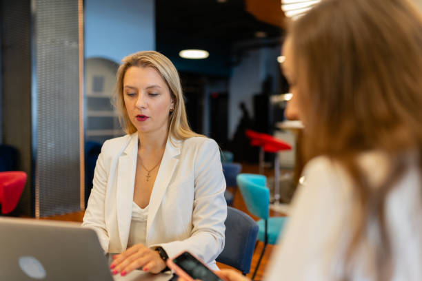 istock Women employees work with devices in coworking area 1857524054