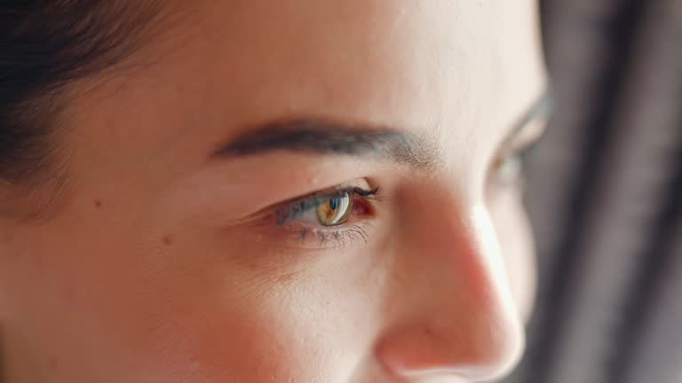 Close Up View Pensive, Dreamful Woman Deep in Thought, Looking Ahead Out a Window Focused Face Embodying Reflection, Motivation and Ideas, Cropped to Accentuate the Intensity of Her Expression.