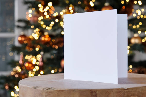 istock Standing blank greeting card mockup in front of a christmas tree 1857536332