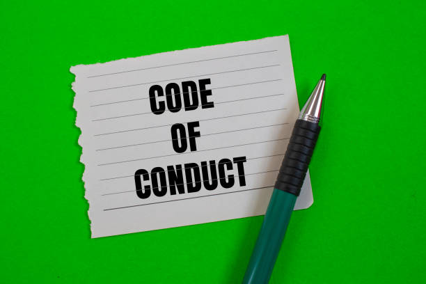 istock Code of conduct lettering on ripped paper 1857557457