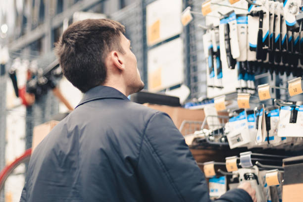 istock A young man inspects goods in a store. 1857568536