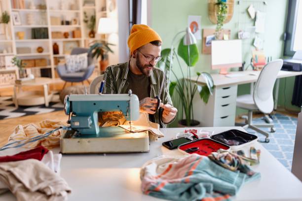 istock Creative man sewing and repairing clothes 1857608716